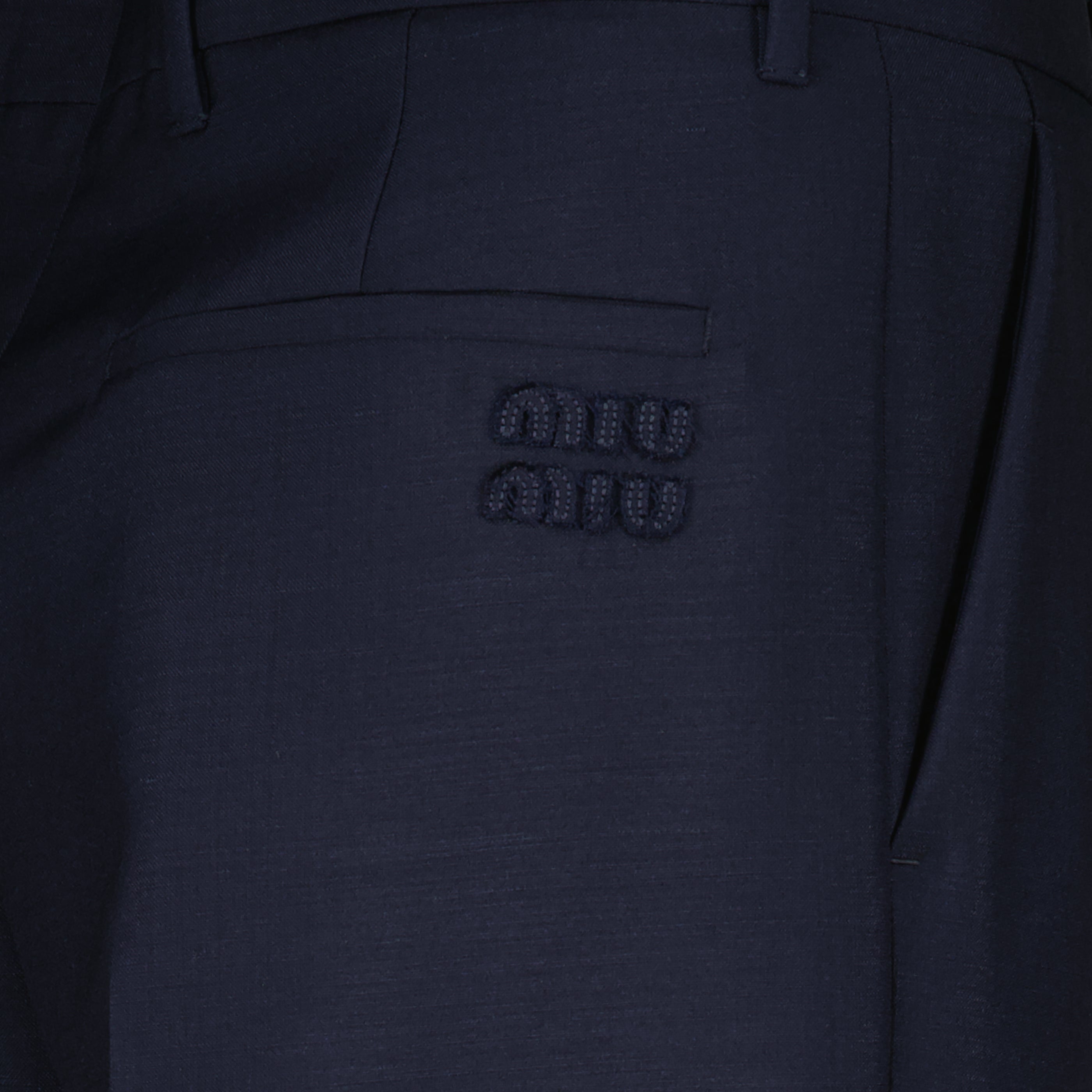 Image of the item Dark blue wool cigarette trousers by the brand Miu Miu for Women - Spring-Summer 2026 - Detailed View_1