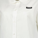 Imagem da camisa branca em popeline da marca Miu Miu para mulher - Temporada Primavera-Verão 2026 - Vista Detalhada_1