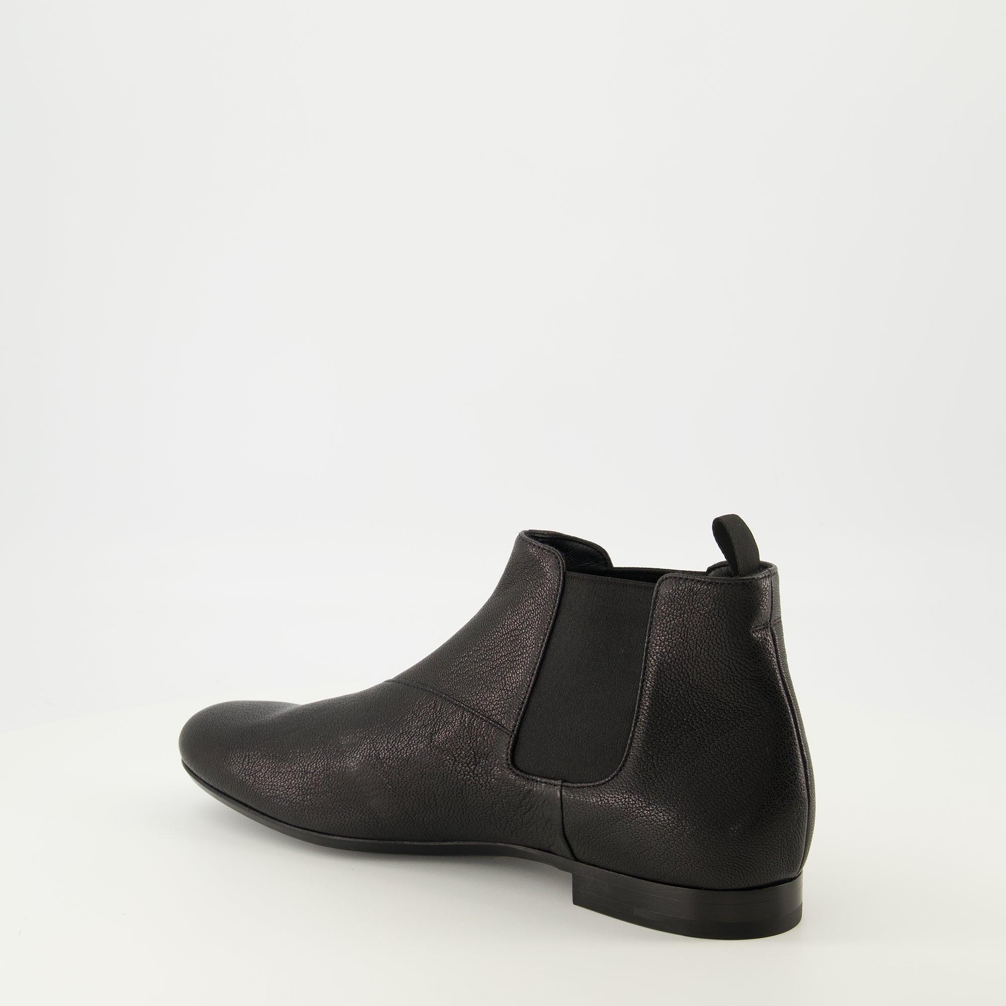 Image of the black leather Chelsea boots by Prada for Men - Spring-Summer 2026 - Back right three-quarters view