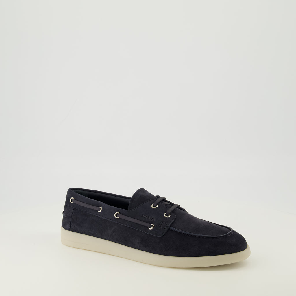 Image of the navy blue suede loafers from the Prada brand for men - Spring-Summer 2026 season - Three-quarter front right view