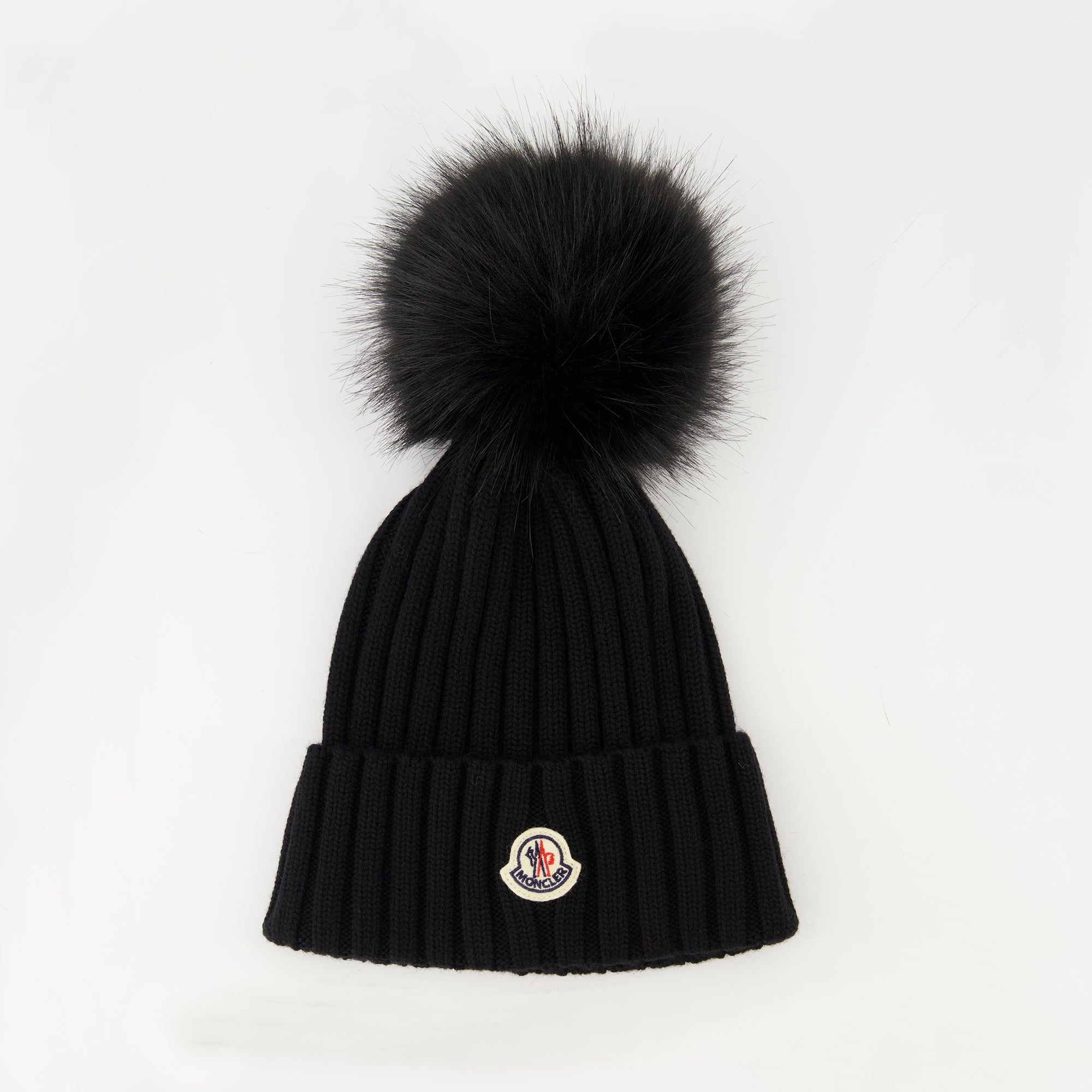 Image of the article Wool beanie with pompom from the brand Moncler for Women - Autumn-Winter Season 2025 - Front View