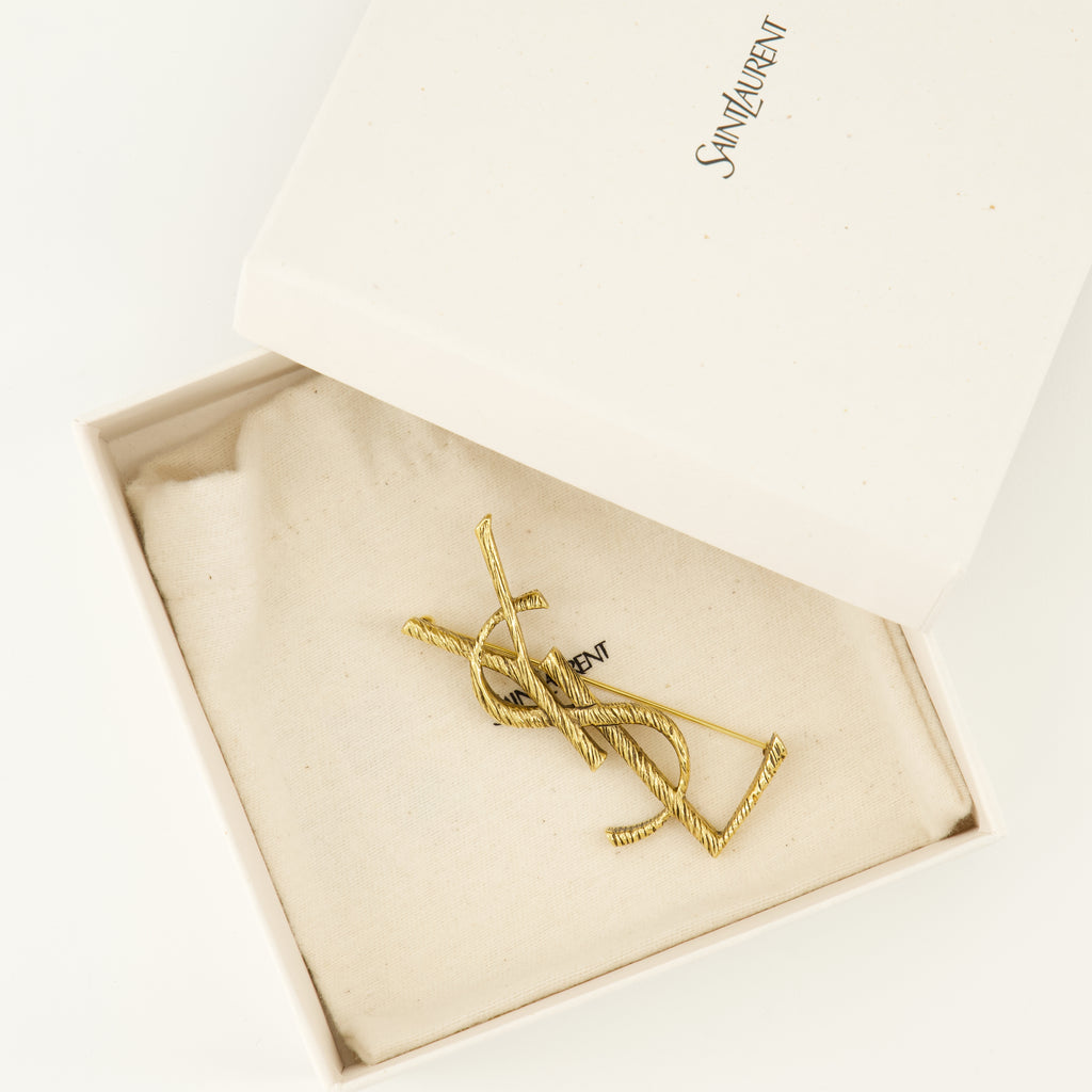 Bijoux Broche Cassandre doré en laiton Saint Laurent Doré Femme